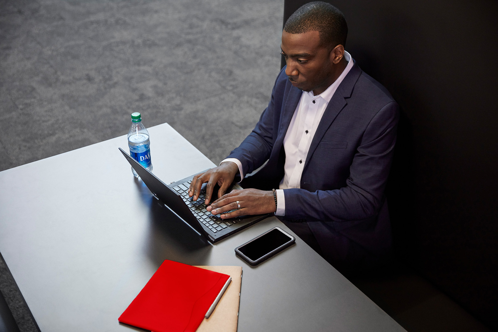 Man in suit working on laptop computer