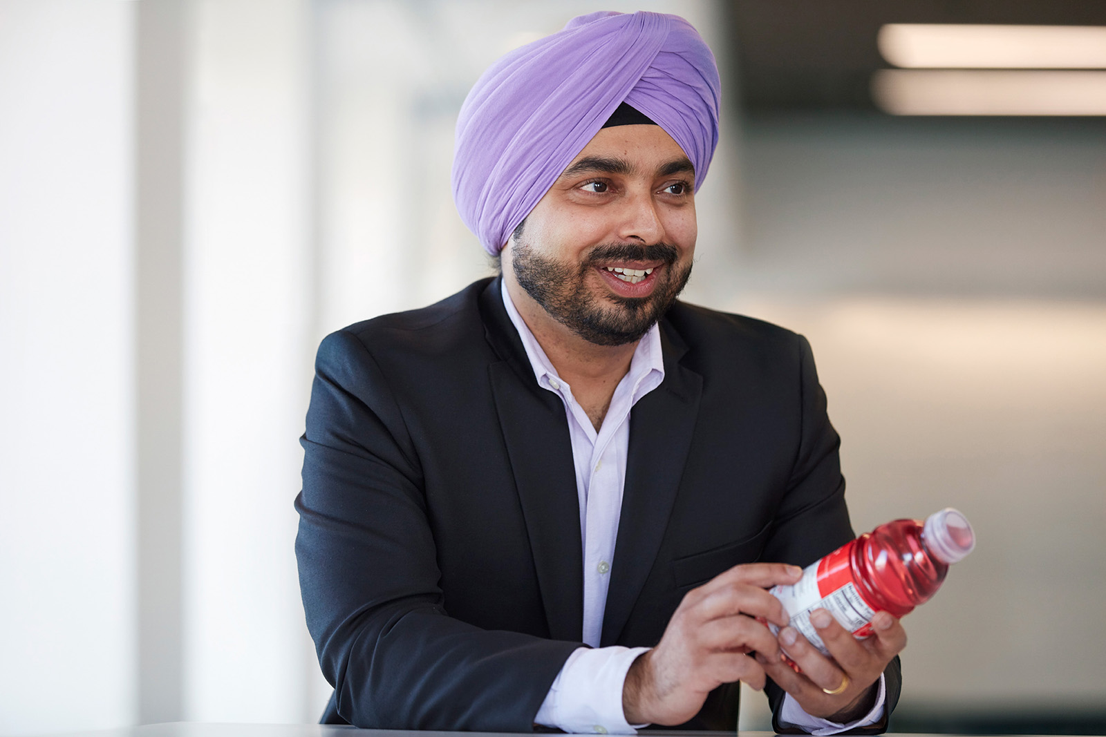 Man in suit holding flavored water product